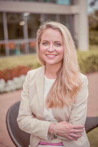 Smiling blonde woman in beige blazer