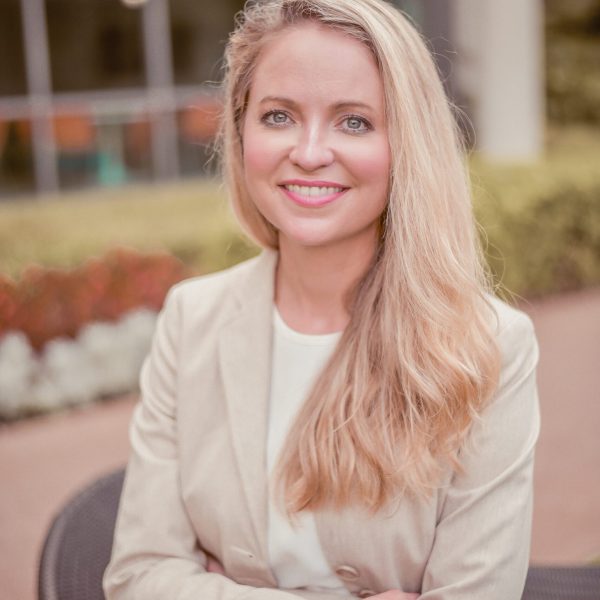 Smiling blonde woman in beige blazer